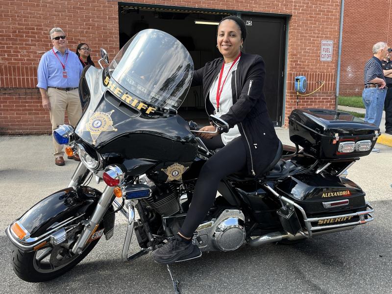 Community member sitting on a Sheriff's Office motorcycle