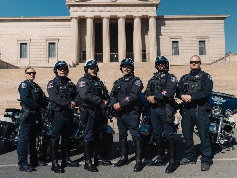 APD police officers in front of temple.