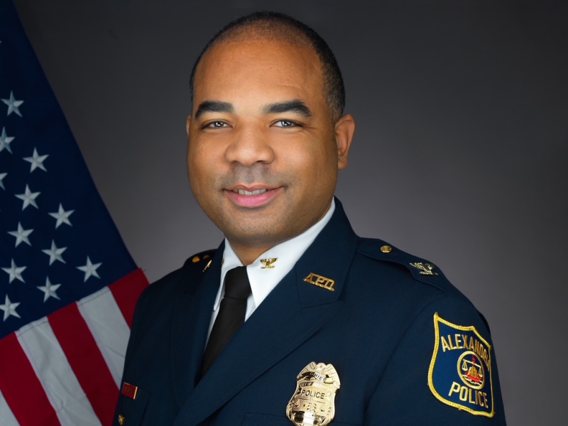Portrait of Chief Tarrick McGuire in his dress uniform with a United States flag in the background.