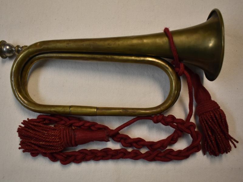 A Civil War era bugle from the collection of Fort Ward Museum is ornamented with red tassels.