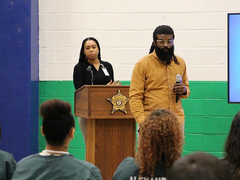 two graduated students speaking with inmates