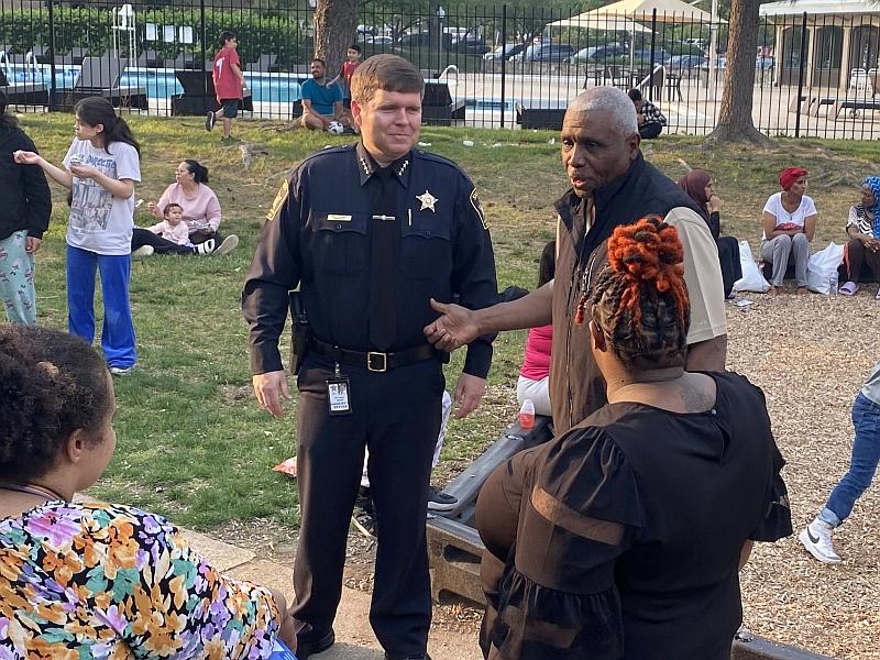 sheriff and community leader jim paige with residents at outdoor neighborhood event