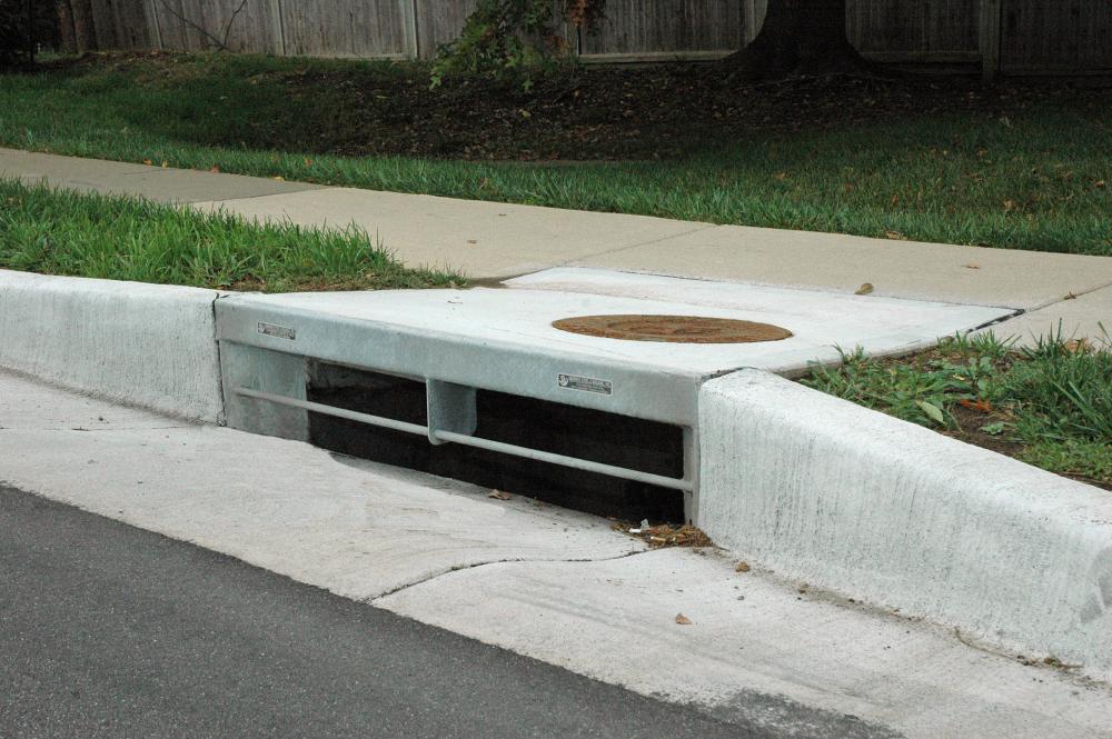Photo of a newly installed curb inlet, the space along a road curb that allows water to drain off the road into the storm sewer system.