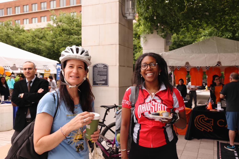 Two cyclists enjoying the snacks provided at Bike to Work Day.