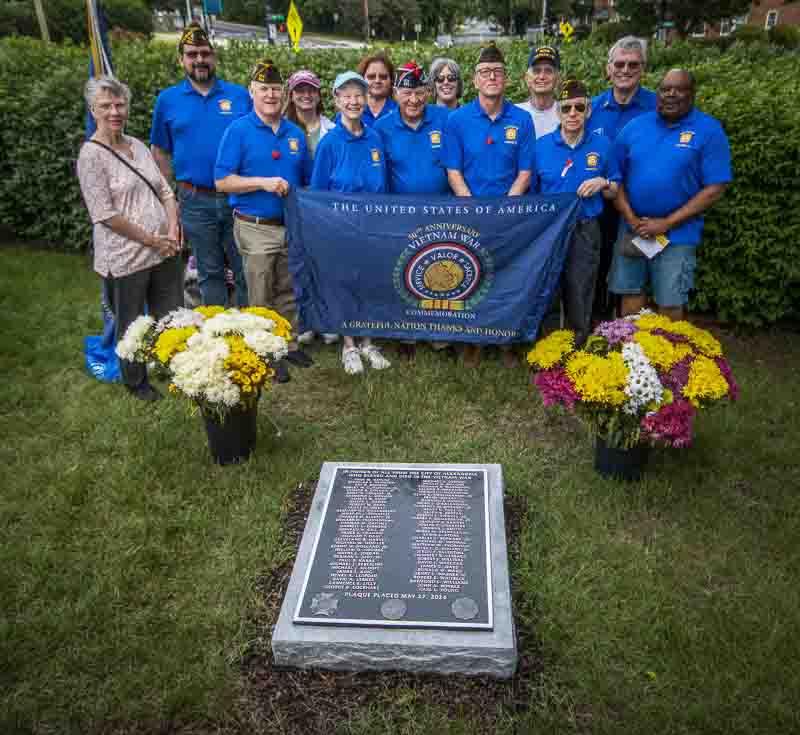 VFW members in blue shirts with plaque and banner