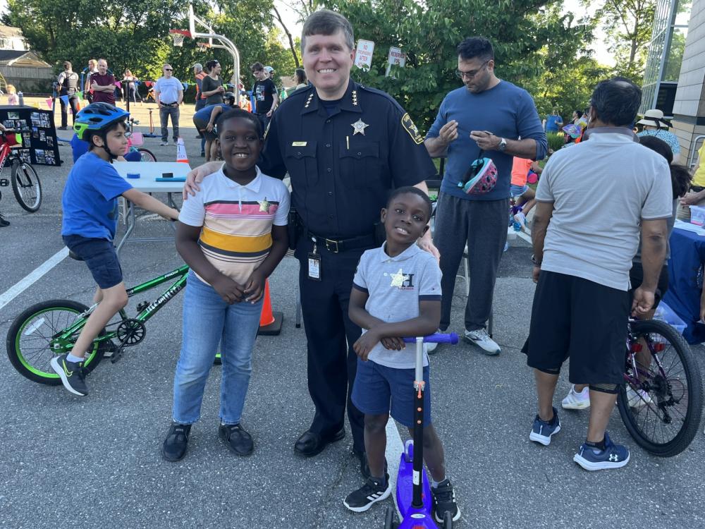 Sheriff with two kids a bicycle rodeo for children