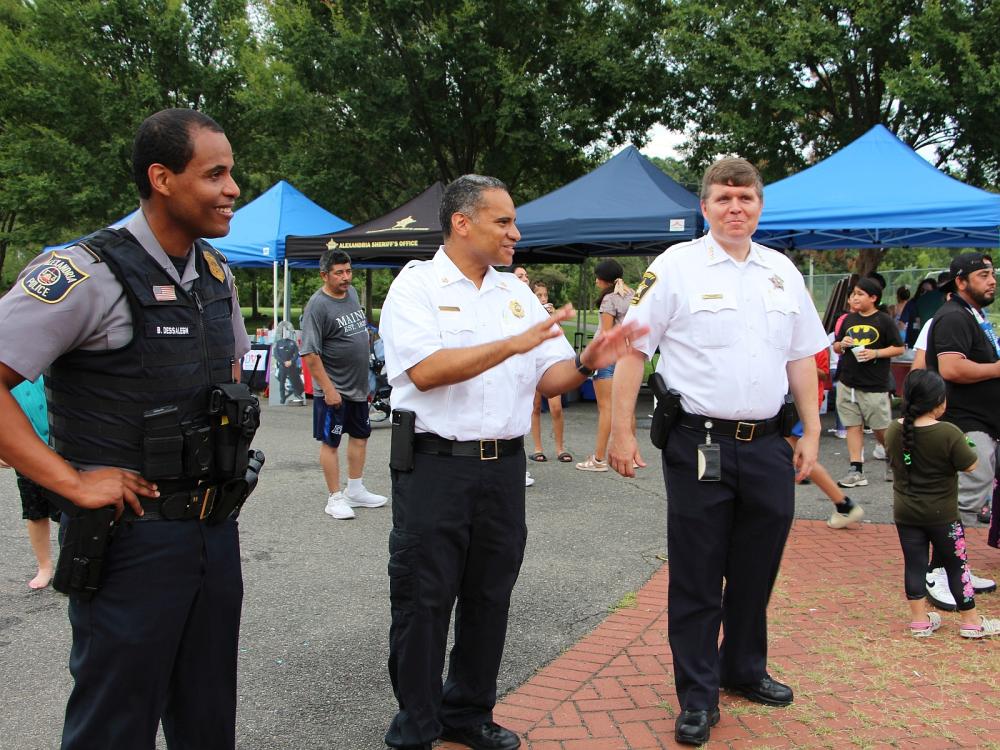 Police commander, Fire Chief and Sheriff smiling at National Night Out even in Chirilagua