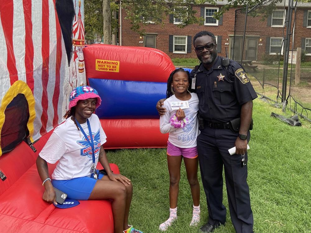 Deputy with a woman and child at a National Night Out event