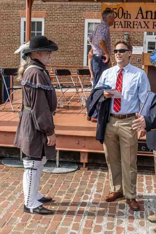 Man in colonial dress talking to people on Market Square