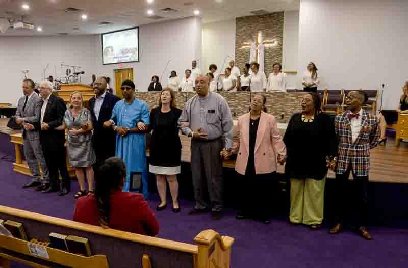 line of people with arms linked