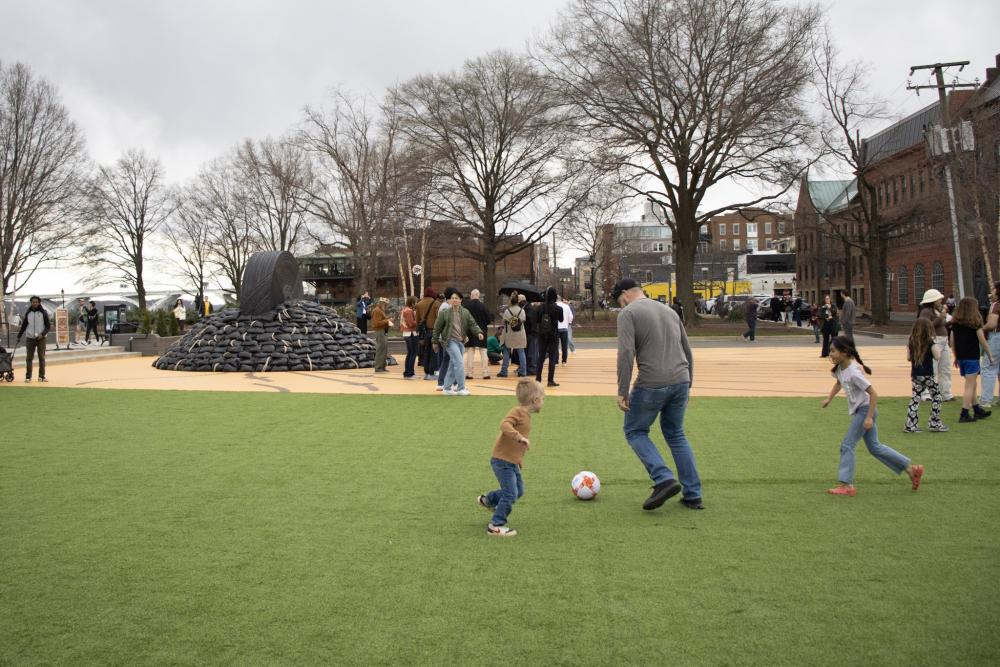 A family plays soccer on the turf