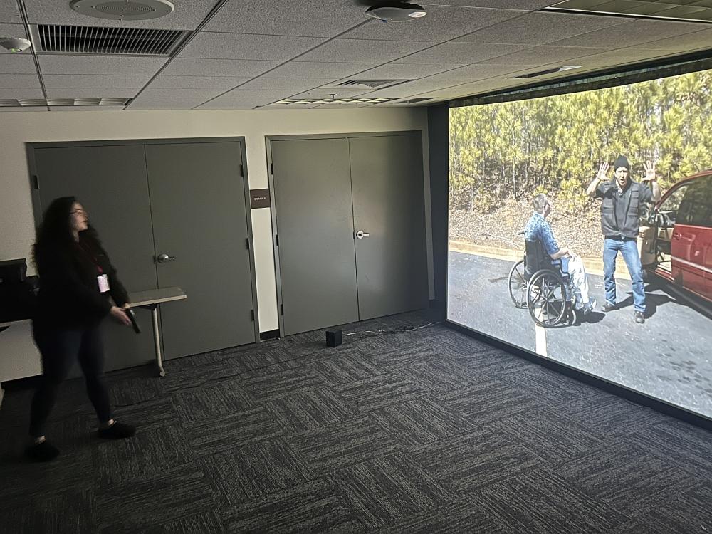 A civilian tries a law enforcement training firearms simulator