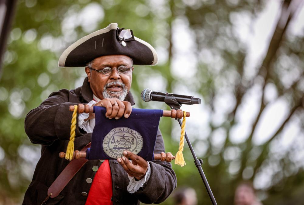 The town crier reading from a scroll
