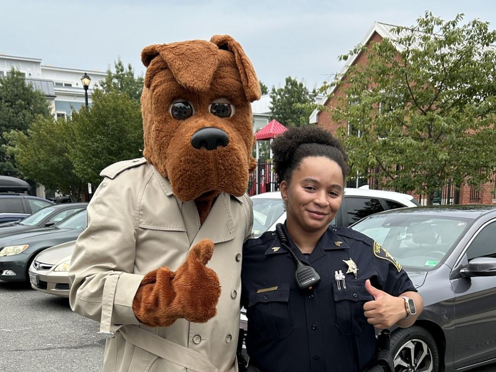 McGruff the Crime Dog and Sheriff's sergeant in blue uniform, both giving thumbs up