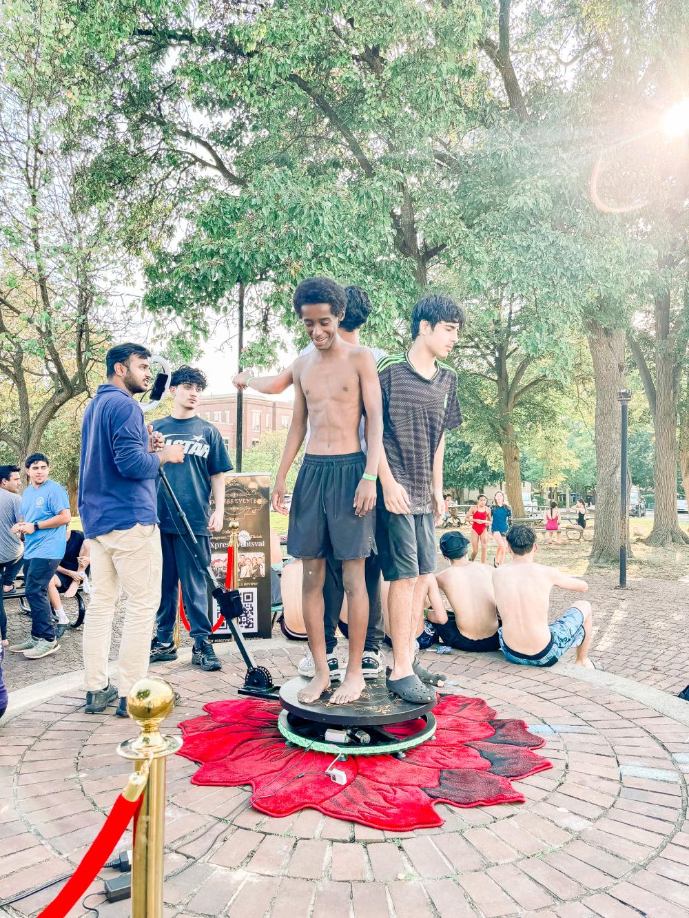 Image of teens standing on a mobile 360 camera