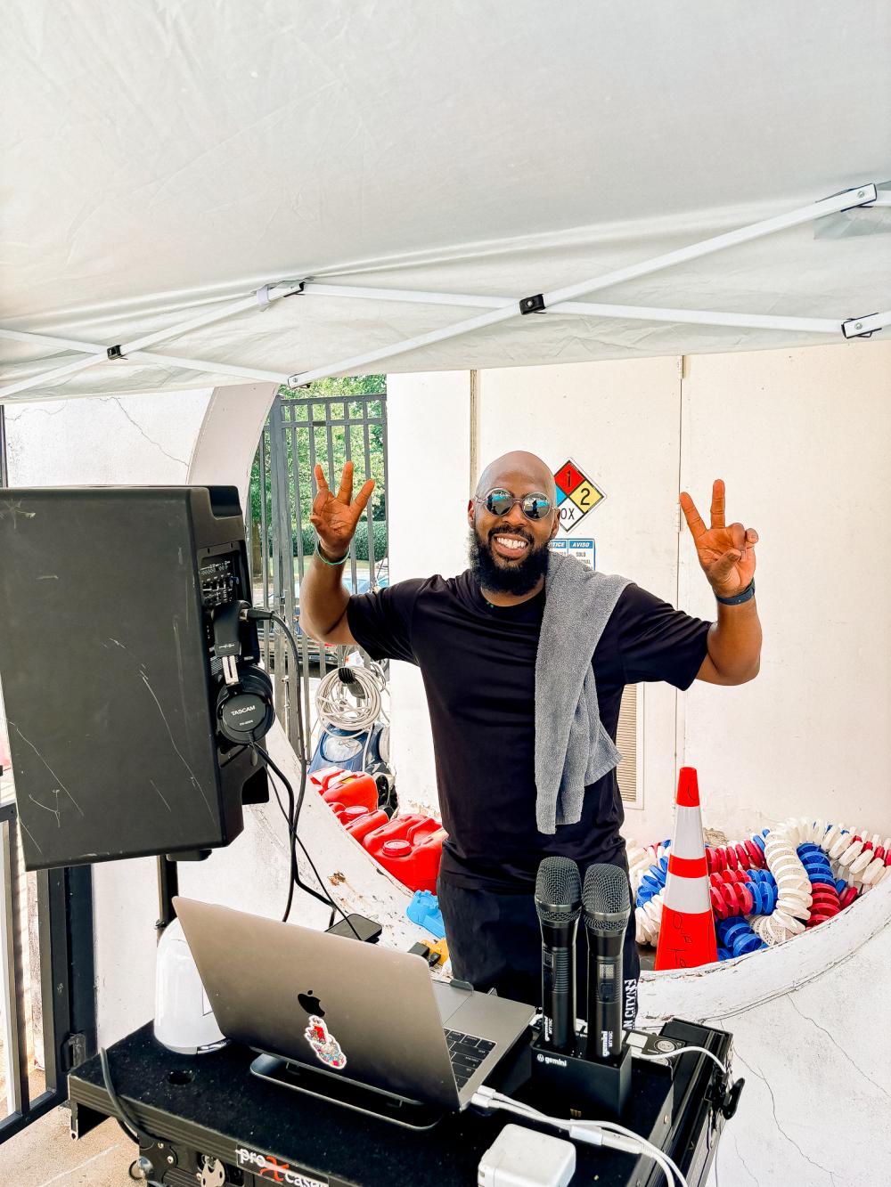 Image of a man in a black shirt with sunglasses