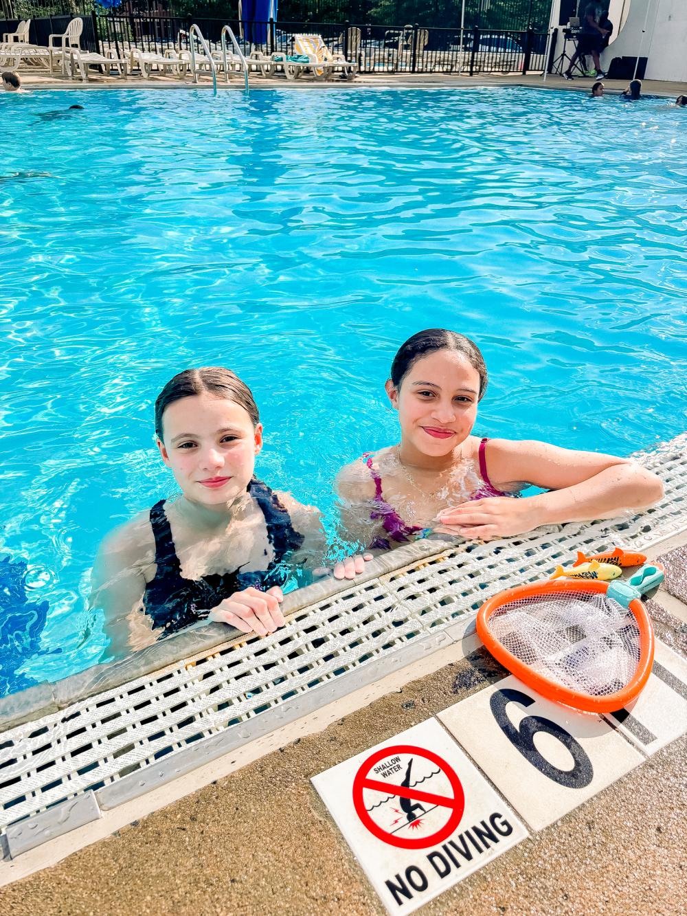 Image of two female teens in an outdoor pool
