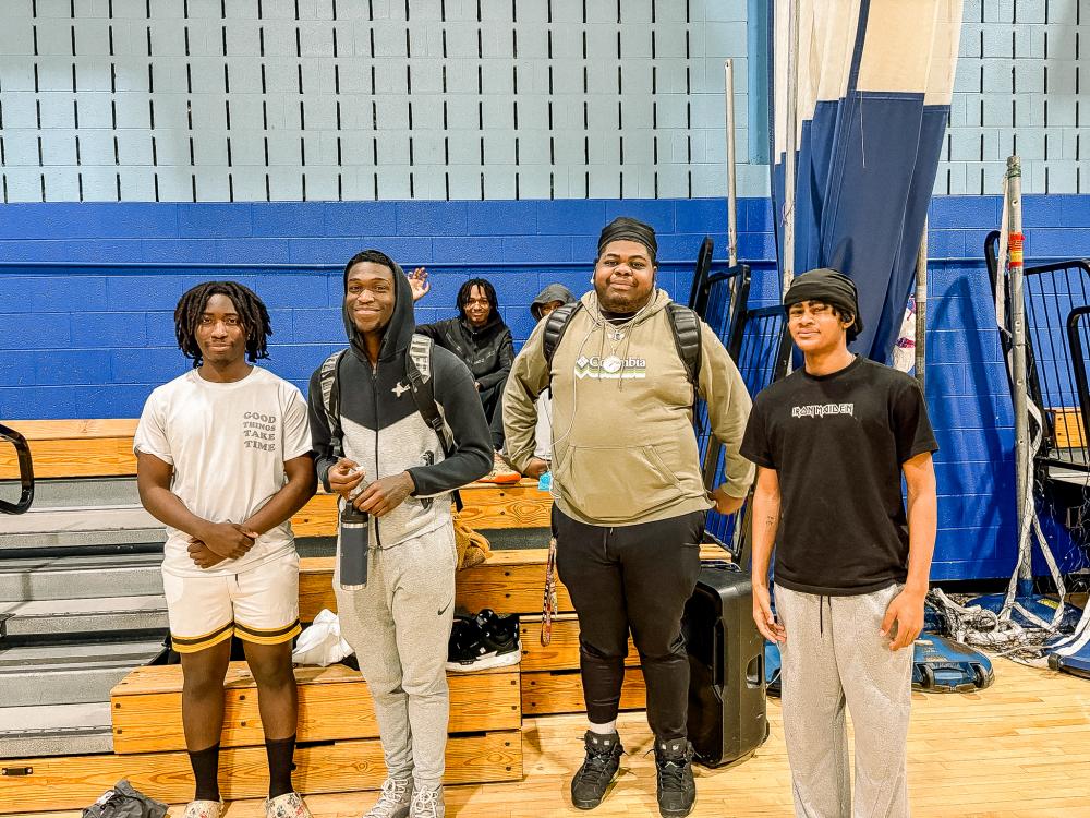 Group of teenage boys in a gym posing for the camera
