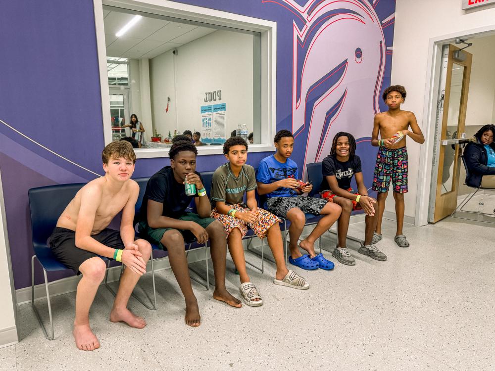 Boys eating snacks and sitting on chairs