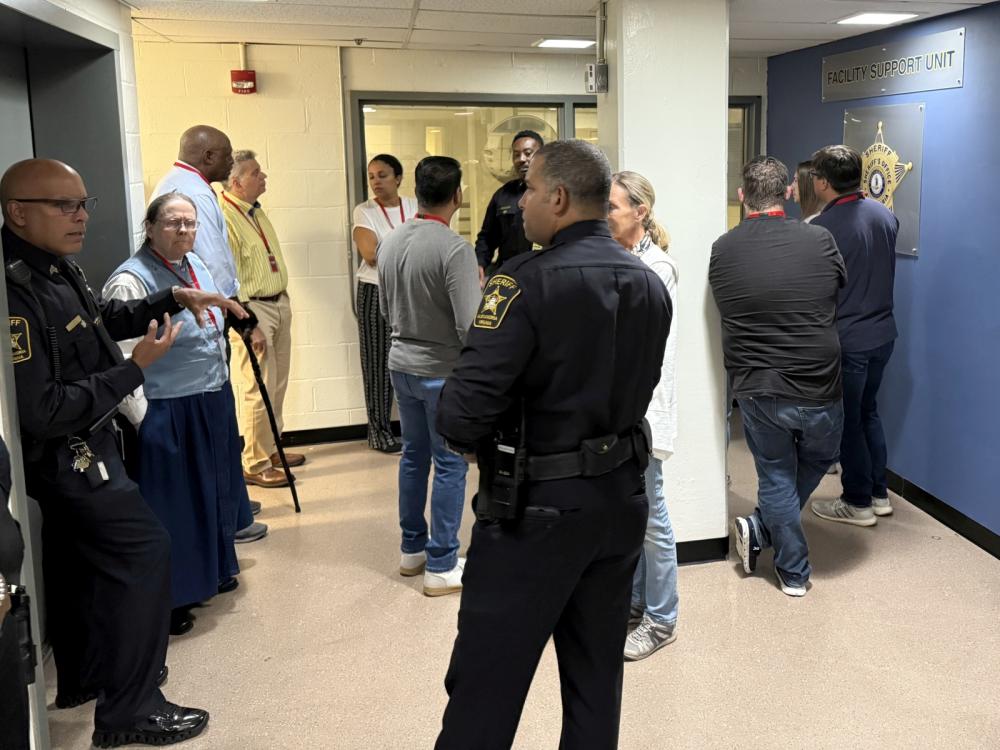 Deputies speak with several community members on tour of jail