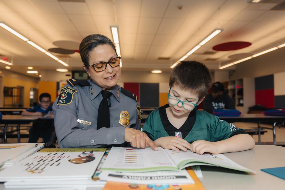 Lt Magyar helping child with math.