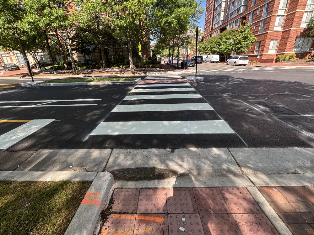 A photo of a new crosswalk, curb ramps, and pedestrian median island on Holland Lane.