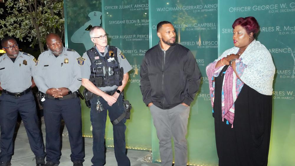 Participants join hands in prayer outside Police Headquarters, reflecting the spirit of unity at the heart of Faith & Blue.