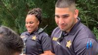 two deputies at community event with youth