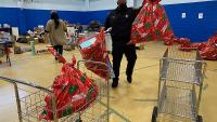 deputy packing large holiday gift bags