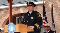 Sheriff wearing formal uniform speaking at podium at outdoor event