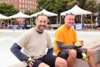 Two cyclists resting on the edge of the Market Square Fountain at Bike to Work Day 2024.