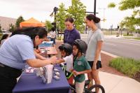 Young cyclists speaking with City services representatives.