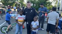 Sheriff with two kids a bicycle rodeo for children