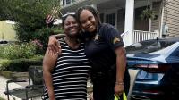 Resident and deputy sharing a hug at a National Night Out event