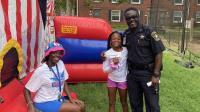 Deputy with a woman and child at a National Night Out event