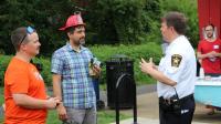 Two neighbors talking with Sheriff Casey at a National Night Out event for the Taylor Run Citizens' Association