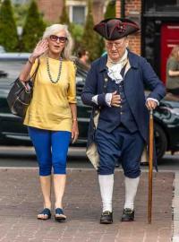 Woman walking with man in colonial dress