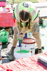 Muralist mixing paint