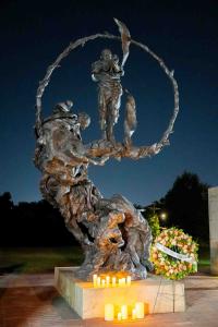 Statue with candles and wreath