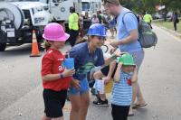 Parent and two kids wearing T&ES hard hats