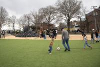 A family plays soccer on the turf