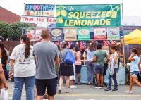 A group of people line up at the vendor booths