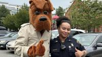 McGruff the Crime Dog and Sheriff's sergeant in blue uniform, both giving thumbs up
