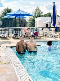 Image of two teens at an outdoor pool