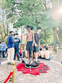 Image of teens standing on a mobile 360 camera