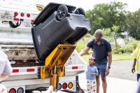 Attendees observe a trash truck