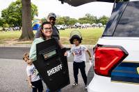 A family poses with a Sheriff Department shield