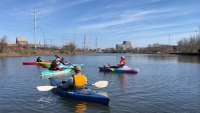 Five kayakers on the river at Kayak Run
