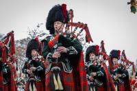 group in scottish garb playing bagpipes