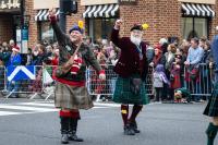 two men in scottish garb wave to the crowd